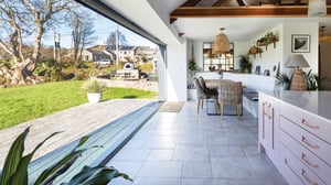 large open bifold door connecting open plan living with the Cornish countryside