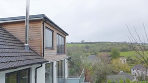 Photo of a timber cladded dormer with views over the surrounding countryside