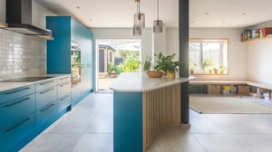 teal kitchen opening out onto sunny garden