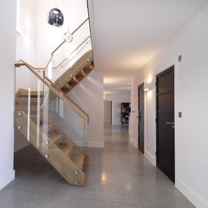 hallway with glass guarded stairs