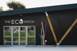 view of black metal clad building showing wooden support posts