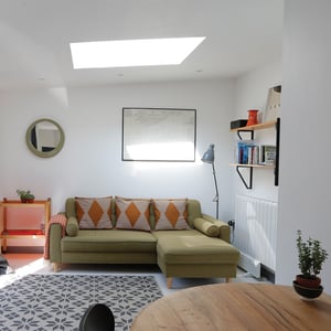 green sofa in living space with shelving
