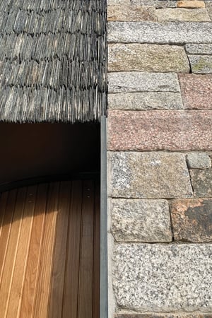 Detail of stone against slate and timber finishes