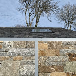 stone wall with recess aluminium downpipw
