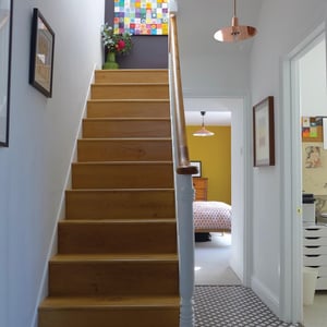 wooden staircase in victorian terrace with view of bedroom beyond
