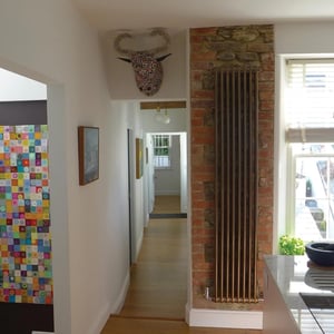 full hight radiator on exposed brick and stone wall