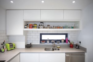 white and grey kitchen with dark grey slot window