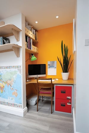 office space within an recess with bright yellow wall