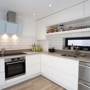 modern kitchen with white units and grey dekton worktop