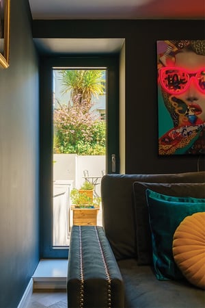 darkly painted entertainment room with floor to ceiling window