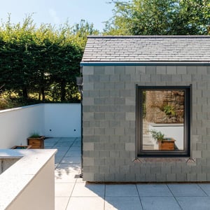 slate hung external wall with large rectangular window