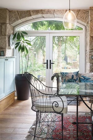 dining area with double doors leading to garden