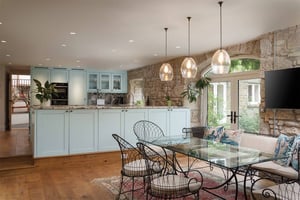 light blue wooden kitchen with dining area