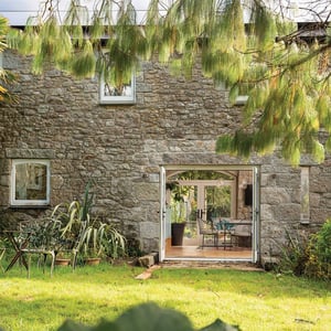 view from garden with double doors to kitchen dining area