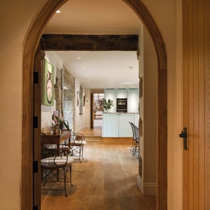 view through arched doorway leading to kitchen dining area