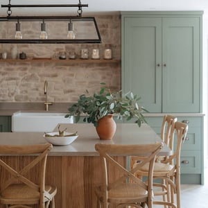 kitchen island with high stools and bowl of pears