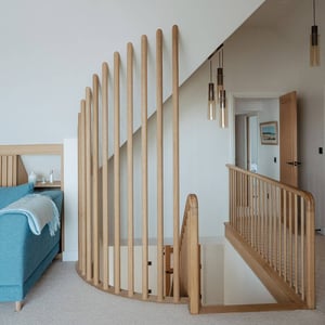 wooden guarded stairs with curved handrail