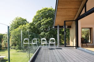stepping out of the living room onto a new balcony with glass guarding