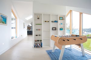 table football with white shelving unit behind