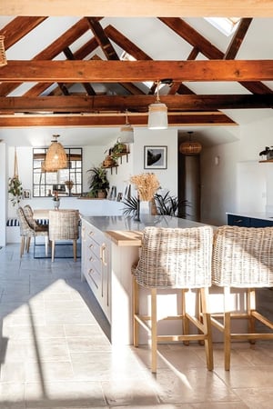 kitchen island with exposed trusses and lots of natural light