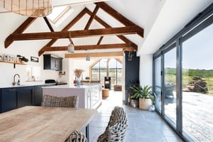 internal view looking back towards open plan living room and views outside towards surrounding fields