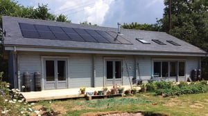 external view of timber self build kit home with garden in front 