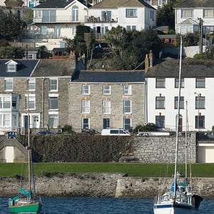 View of stone finished Victorian terrace property from the water