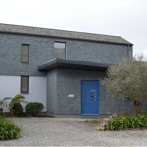 new porch extension with slate cladding and large roof overhand