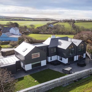 elevated view of white render and slate hung home