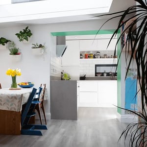 internal view of open plan kitchen dining room with light coming from large rooflight