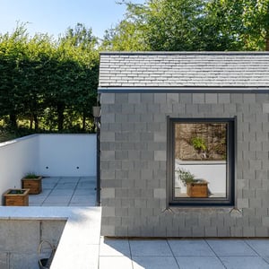 slate cladded extension with concealed gutters and large window